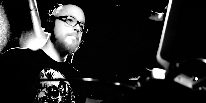 Black and white photo of Dave Ghoul DJing.